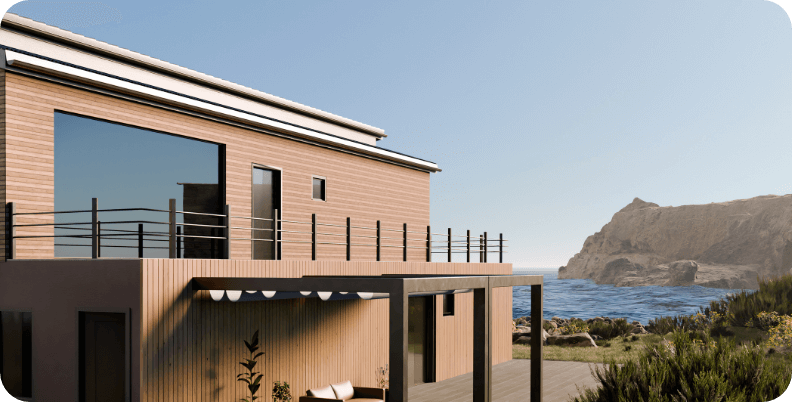 Modern two-storey coastal home with light timber cladding and large glass doors opening to a deck, set against dramatic rocky coastline with native coastal vegetation in the foreground.